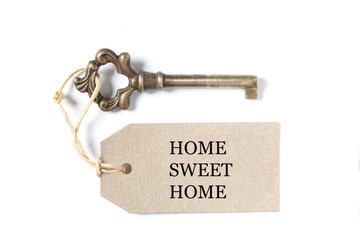 old antique key isolated with a label on white background with copy space