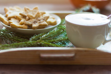a Cup of coffee with a thick foam and Christmas cookies with sugar and cinnamon