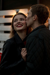 the guy kisses the smiling girl