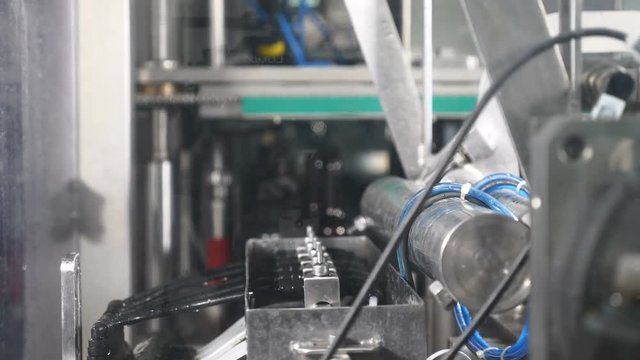 Beer factory. A part of automatic beer production techological cycle. Empty bottles are washed before filling with beer. Robotic touch. 4k