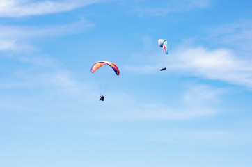 Two paragliders against the sky. Russia, Republic of Crimea. 06.13.2018. Flight of two paragliders...