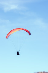Paraglider against the sky. Russia, Republic of Crimea. 06.13.2018. Flight of a paraglider athlete against the sky