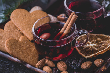 Mulled wine with heart shaped gingerbread cookies, almonds, raisins and dried sliced oranges.