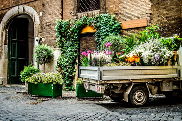 A truck filled with flowers on a Roman street. Rome. Italy