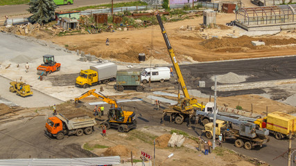 Orange construction excavator loading old tram rails into truck timelapse.