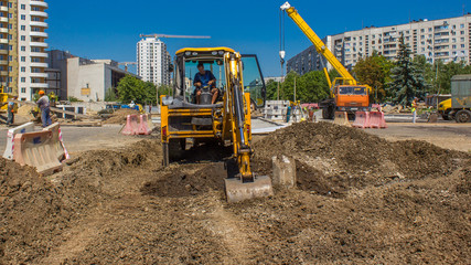 Industrial truck loader excavator moving earth and diging ground timelapse