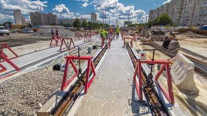 Tram rails at the stage of their installation and integration into concrete plates on the road timelapse hyperlapse.