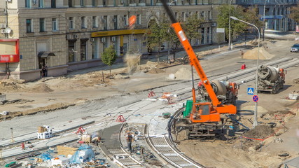 Concrete works for road construction with many workers and mixer timelapse