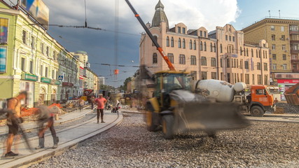 Fototapeta premium Concrete works for road construction with many workers and mixer timelapse