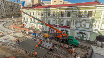 Concrete works for road construction with many workers and mixer timelapse