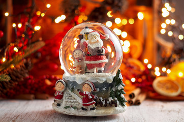 Musical Snow Globe with Santa Claus on bokeh background