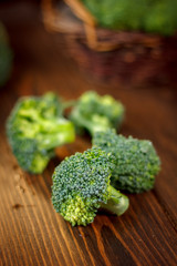 Beautiful broccoli crowns on wooden board.
