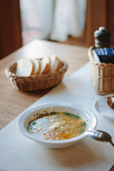 Nice and hot soup at the white ceramic plate at the restaurant.