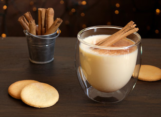 Christmas cocktail eggnog on a light background, in a glass mug.