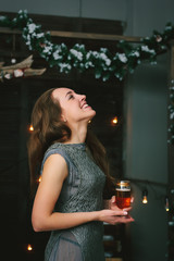 Portrait of laughing girl with champagne in hands during christmas celebration.