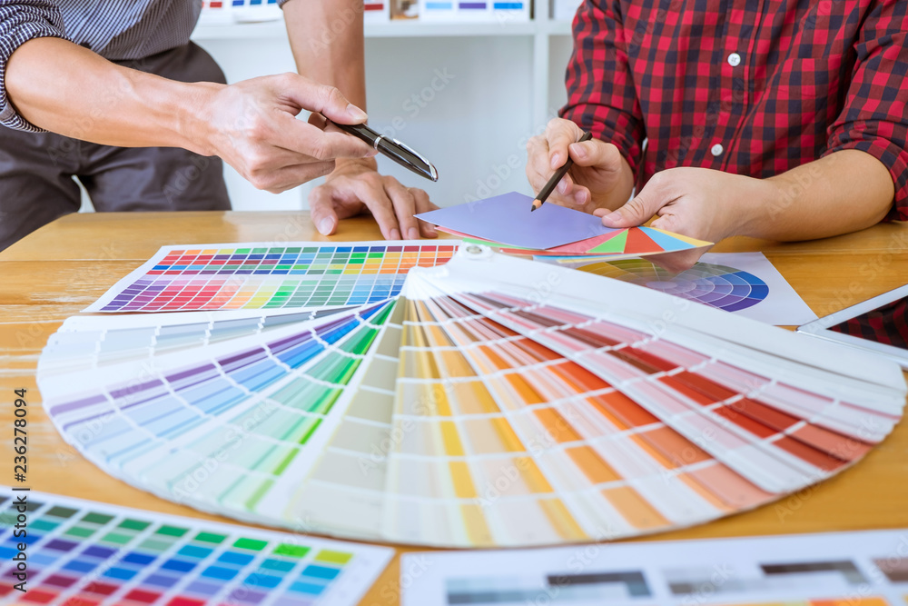 Poster teamwork of young creative designers working on project together and choose color swatch samples for