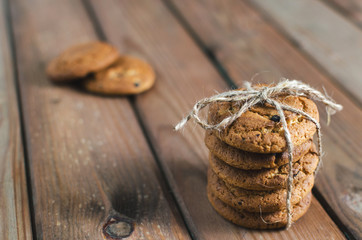 Homemade fresh oatmeal cookies on brown wooden table.