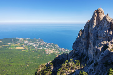 Fototapeta na wymiar Resort town on the seashore. Russia, the Republic of Crimea. 13.06.2018. Town of Gaspra. View from Mount Ai-Petri