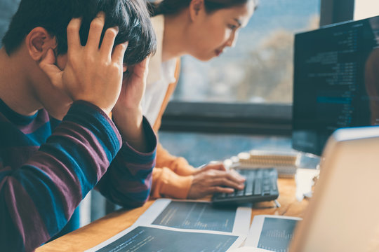 Professional Development programmer cooperating meeting and brainstorming and programming website working in a software and coding technology, writing codes and data code