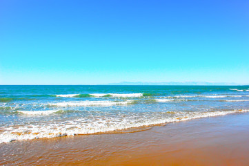 Photo of a sandy beach with waves
