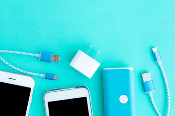 smartphone with adaptor and USB charging cables in top view