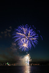 Colorful firework bursting over the river