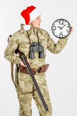 female hunter with santa hat and double barreled shotgun Isolated on white background.