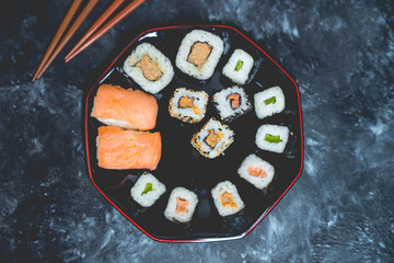 Japanese cuisine - sushi on a dark, stone background