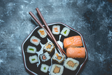 Japanese cuisine - sushi on a dark, stone background