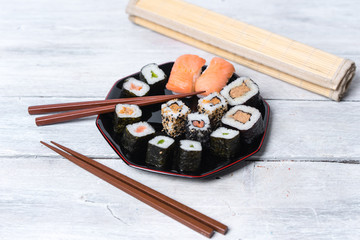 Japanese cuisine - sushi on a white, wooden background