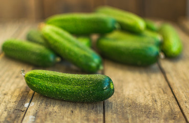 Fresh cucumbers on old wooden table