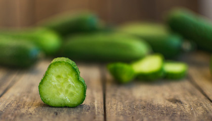 Fresh cucumbers on old wooden table