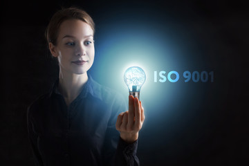 The concept of business, technology, the Internet and the network. A young entrepreneur working on a virtual screen of the future and sees the inscription: ISO 9001