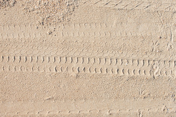 Tire car paint on sandy beach surface.