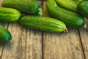 Fresh cucumbers on old wooden table