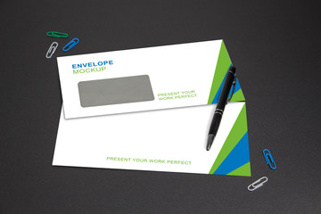 Envelope Mockup on anthracite gray Background with Office Decoration