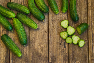 Fresh cucumbers on old wooden table