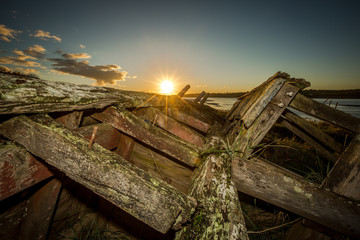 Obsolete small boats and barges were beached on the banks of the tidal River Severn in...