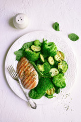 Grilled chicken fillet with green vegetable salad.Top view with copy space.