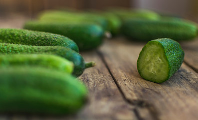 Fresh cucumbers on old wooden table