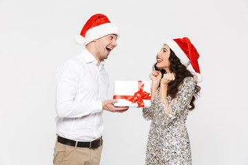 Happy couple in red hats celebrating New Year