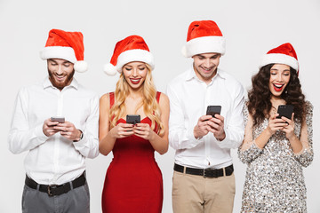 Group of happy friends dressed in red hats
