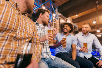 Friends drinking beer at pub.