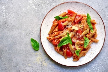 Penne pasta with tomato in red sauce.Top view with copy space. - obrazy, fototapety, plakaty