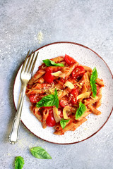 Penne pasta with tomato in red sauce.Top view with copy space.