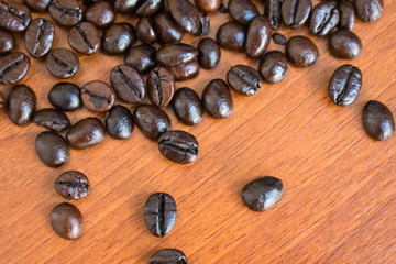 coffee beans and cinnamon sticks on wooden background