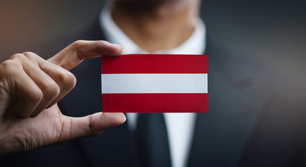 Businessman Holding Card of Austria Flag