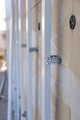 Installation of metal profiles on the walls of the house