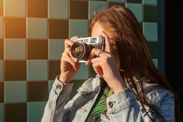 Lifestyle sunny fashion portrait of young stylish woman walking on street, with camera, smiling enjoy weekends.