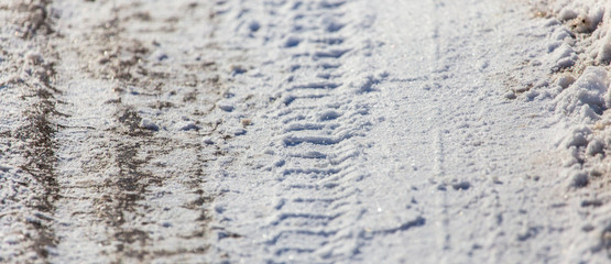 Traces of cars in the snow as a background